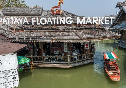 Historic Pattaya Floating Market featuring traditional Thai architecture and colorful boats.