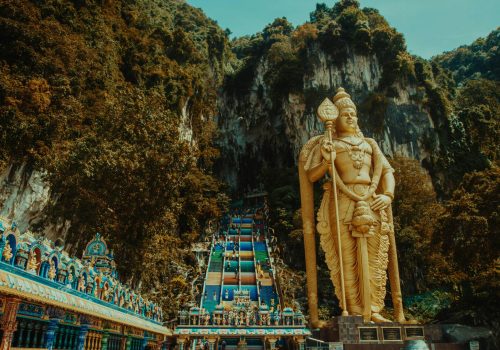 Majestic statue of Lord Murugan at Batu Caves, a famous tourist destination in Malaysia.